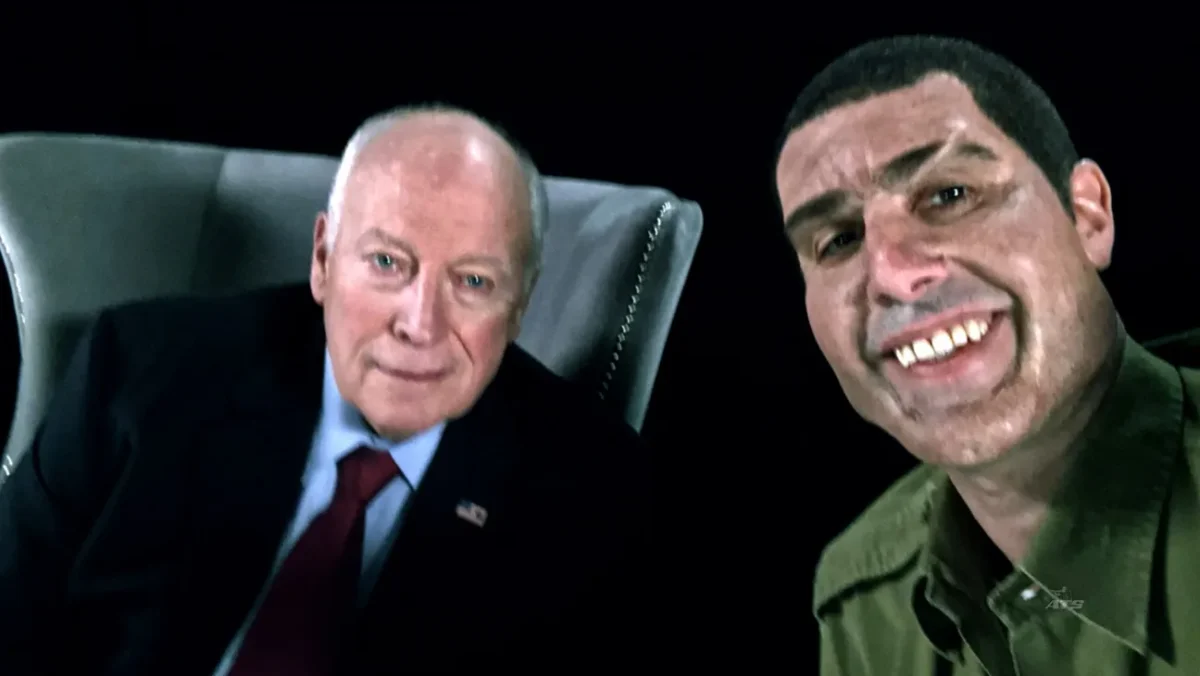 Sacha Baron Cohen, as his character Erran Morad, poses alongside former US Vice President Dick Cheney in a controversial scene from *Who Is America?*, where he gets Cheney to sign a "waterboarding kit."