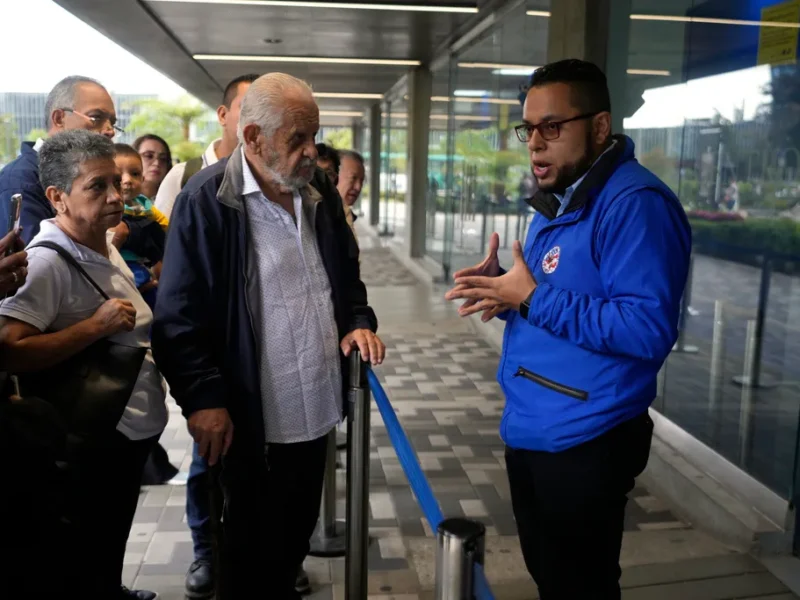 A U.S. consular official explains to people with scheduled visa document submissions that their appointments were canceled due to Colombian President Gustavo Petro's refusal to accept repatriation flights of Colombian citizens from the U.S., at a U.S. Embassy Applicant Service Center in Bogota, Colombia, Monday, on Jan. 27, 2025. Fernando Vergara—AP