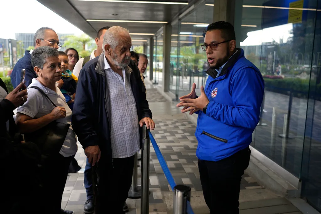 A U.S. consular official explains to people with scheduled visa document submissions that their appointments were canceled due to Colombian President Gustavo Petro's refusal to accept repatriation flights of Colombian citizens from the U.S., at a U.S. Embassy Applicant Service Center in Bogota, Colombia, Monday, on Jan. 27, 2025. Fernando Vergara—AP